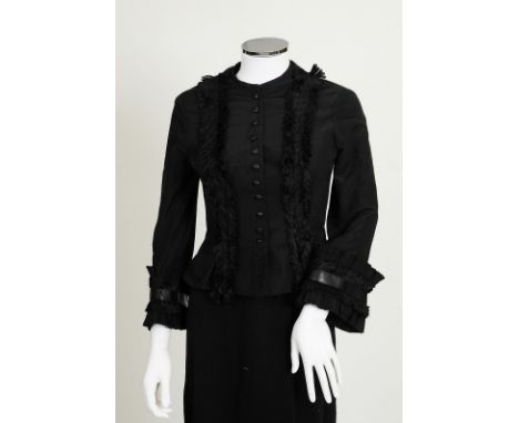 A 2002 Alexander McQueen black silk jacket with fringe detailing to front, elaborate leather and fringe detailing to cuffs, b