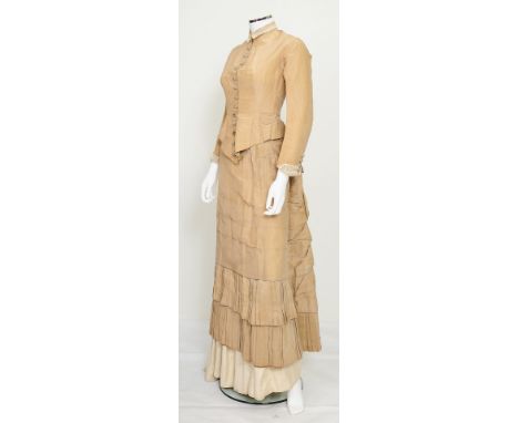 A cream Victorian outfit consisting of a blouse, skirt and underskirt, blouse with lace collar and cuffs, ball button fasteni