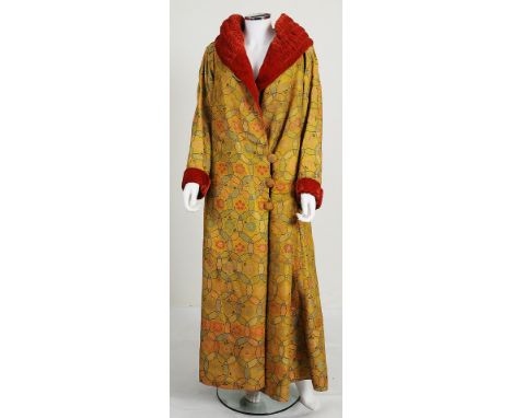 A 1930s long fur lined coat with a bold yellow floral pattern, thick red velvet lapels, pattern highlighted with metallic thr