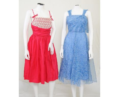 Two 1950s style dresses, the first bright pink with lace detailing to bust and thin tie straps, full skirt, zip to back; the 