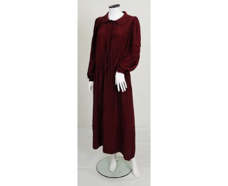 A 1980s Christian Dior dark red dress, blouson sleeves with pleat detailing, elasticated waist, pleat detailing to bottom of 