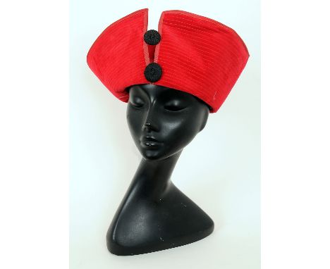 Two red 1960s Frederick Fox hats, one with tall front and button detailing, the other with tall front and black band decorati
