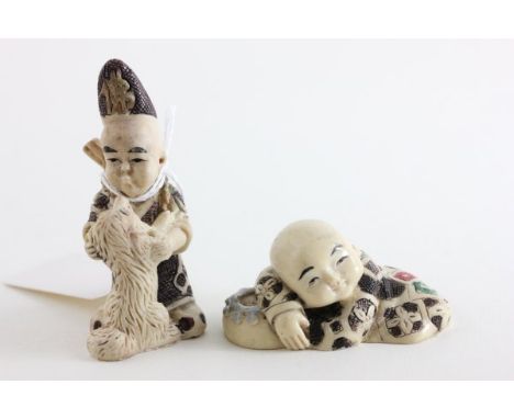 Two Netsuke including a Boy with Dog and a Boy Buddha lying down