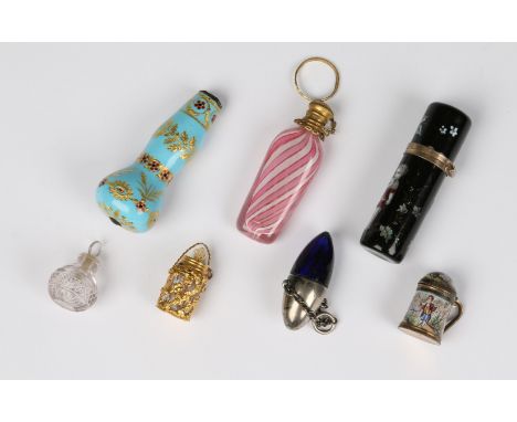 A GILT METAL AND ENAMEL SCENT BOTTLE with hinged lid and decorated cherubs, 6.3cm high, a miniature continental gilt metal an