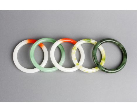 A COLLECTION OF FOUR JADE BANGLES and a further hardstone bangle (5)