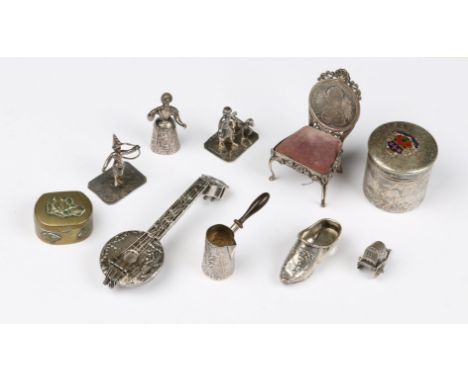 A CONTINENTAL SILVER MODEL of a chair with inset coin, a silver lute shaped scent bottle, a silver clog, a miniature jug with