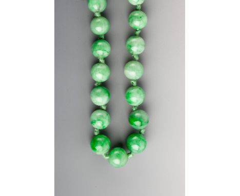 A JADE BEAD NECKLACE, forty nine graduated beads, 10mm down to 5mm, 42cm long (16.5" long)