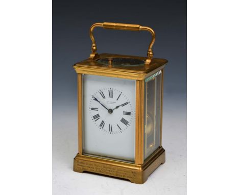 A FRENCH CARRIAGE CLOCK with white enamel Roman dial inscribed J.W. Benson, London, having platform escapement, coiled gong s