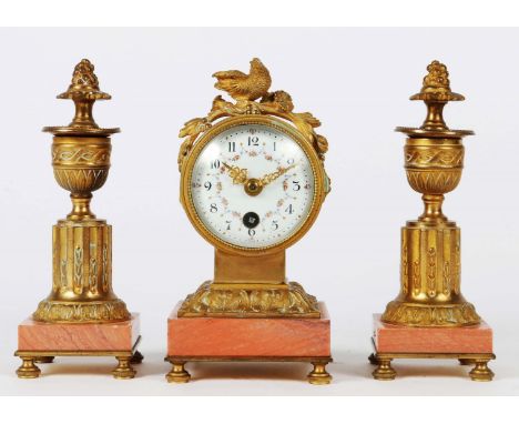 A FRENCH BOUDOIR GARNITURE, the drum head timepiece with white enamel convex Arabic dial decorated with floral swags and orna