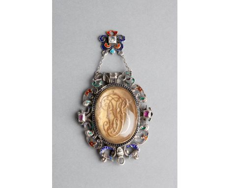 AN AUSTRO-HUNGARIAN PENDANT with inset cypher and in a scrolled frame with enamel and stones with enamel droplet