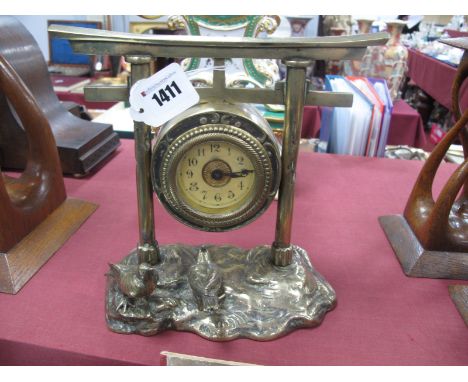 A Victorian Brass Arts and Crafts Style Clock, the clock mechanism under a stylised gate with two birds below - wind-up movem