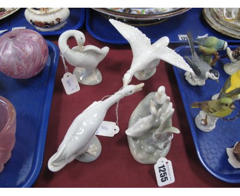 Two Lladro Pottery Figures of Swans and a Goose, Nao pottery figure group of geese and Lladro style pottery figure of a swan.