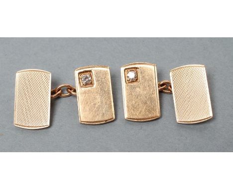 A PAIR OF 9CT GOLD CUFFLINKS, each link with an engine turned panel gypsy set with a diamond of approximately 0.030cts, Birmi