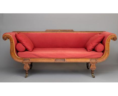 A REGENCY MAHOGANY SCROLL END SOFA upholstered in a red weave, the moulded straight top rail with gadrooned crest, loose cush