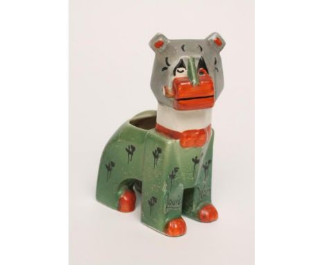 A LOUIS WAIN FUTURISTIC CAT POTTERY SPILL HOLDER, 1920's, the angular feline smoking a pipe, painted in shades of green, burn