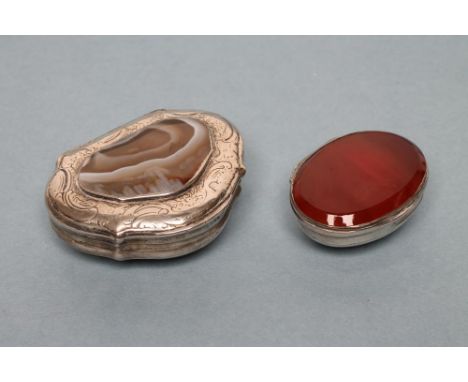 TWO CONTINENTAL WHITE METAL SNUFF BOXES, 19th century, one of lobed serpentine form, the hinged cover inset with a polished a
