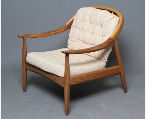 A GREAVES &amp; THOMAS TEAK STICK BACK ARMCHAIR, 1960's, the arched top rail sweeping down to shaped arms on turned supports 