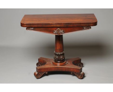 A VICTORIAN ROSEWOOD FOLDING CARD TABLE, the rounded oblong top opening to a circular green baize, foliate carved frieze, the