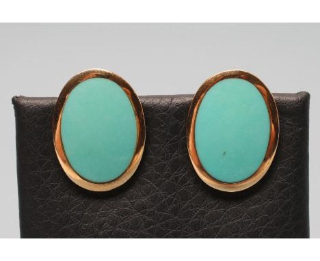 A PAIR OF 9CT GOLD CLIP EARRINGS, the oval panels with rub-over turquoise enamel centres, Sheffield 1991 (Est. plus 21% premi