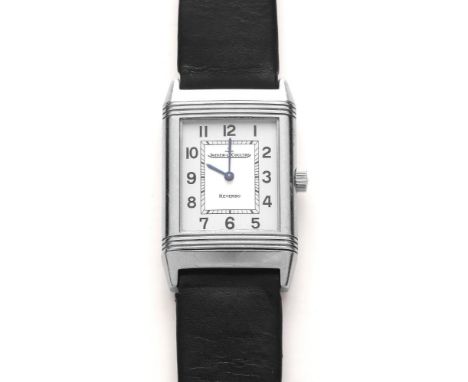 A JAEGER-LECOULTRE REVERSO WRISTWATCH, the oblong silvered dial with black Arabic numerals to the chapter ring, in a ribbed s