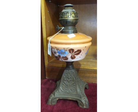 A late-Victorian oil lamp, the orange opaque glass reservoir on metal base, 38cm high.