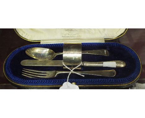 A silver four-piece christening set, comprising: spoon, fork, napkin ring, (all marked 'Eric') and knife, London 1918, in fit