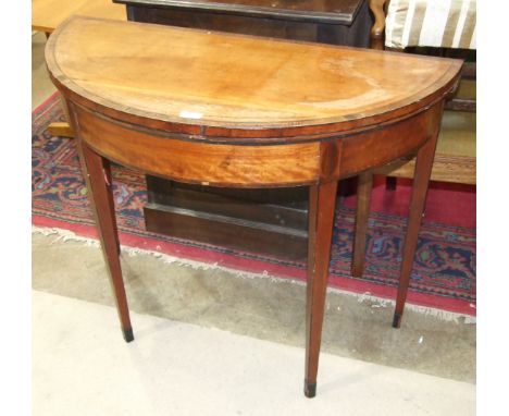 A George III mahogany and satinwood circular fold-over card table on square tapered legs, 92cm diameter, (damaged).