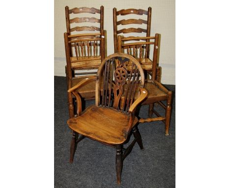 A pair of 19th century elm seated spindle back side chairs, a pair of rush seat ladder back chairs and a beech and elm wheel 