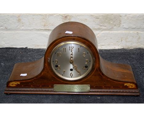 A 1930's walnut and strung Napoleon hat shape mantle clock, the three train movement striking on gongs, faced by silvered Ara