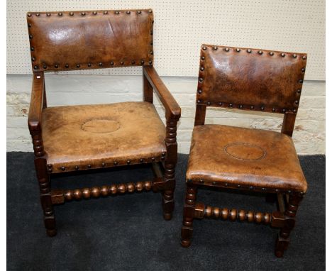 A set of eight early 20th century oak dining chairs, each with studded hide upholstered back and overstuffed seats with studd