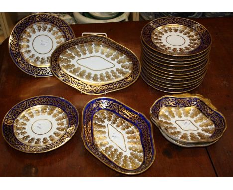 An early 19th century English porcelain part desert service with cobalt blue and gilt  scroll borders and the cavettos decora