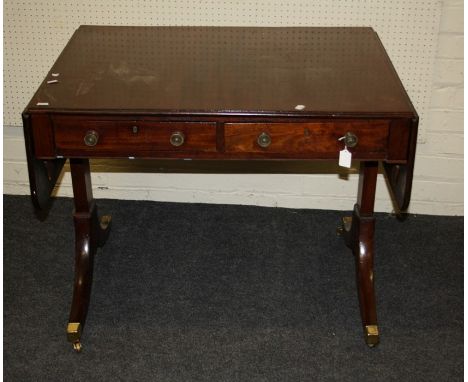 A Geo III figured mahogany sofa table fitted two frieze drawers.Raised on stile ends with, brass castored, inverted sabre sup