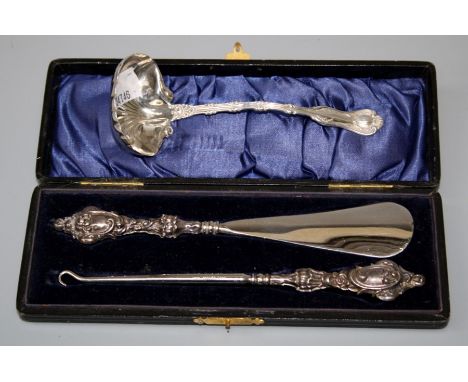 An American Sterling silver sauce ladle, together with a presentation cased button hook and shoe horn with silver handles