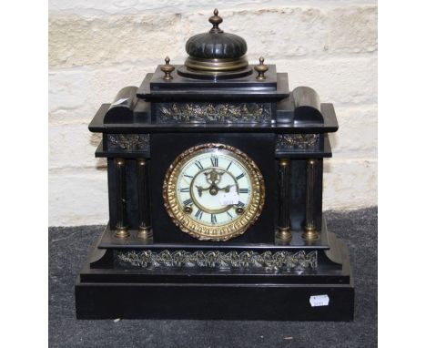 A 19th century architectural form black slate mantle clock with American eight day gong striking movement. 39 cms wide.