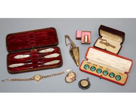 A cased set of early 20th Century silver and green enamel buttons, a 9ct gold bar brooch, a lady's 9ct gold Winegartens wrist