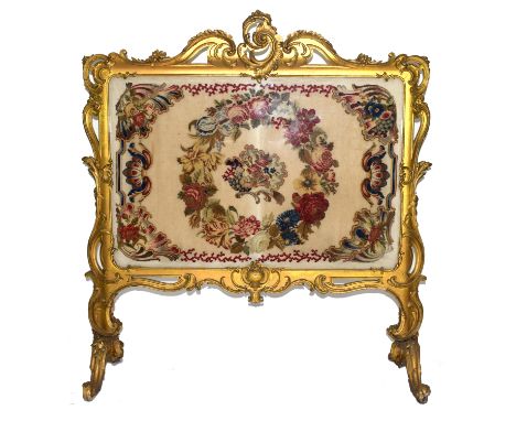 Large gilt gesso framed fire screen, the frame with elaborate foliate and scrolled detail, the centre panel fitted with tapes