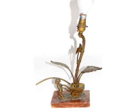 Small gilt metal and marble based table lamp formed as a boy pulling a cart containing a large plant, approx 35cm high