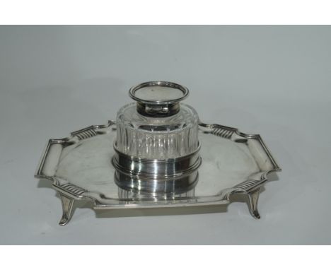 Late Victorian silver ink stand of shaped rectangular form resting on four splayed feet with removable silver mounted ink bot