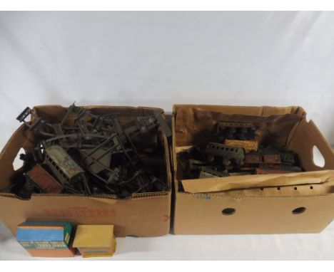 Two boxes of playworn tinplate Hornby Meccano model railway, rolling stock, buildings etc.