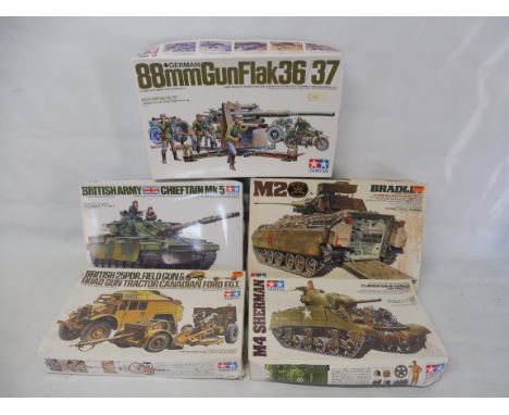 Five boxed Tamiya military kits, chieftain tank, Bradley, Sherman (partly assembled), Field Gun and German Gunflak 36/37, all