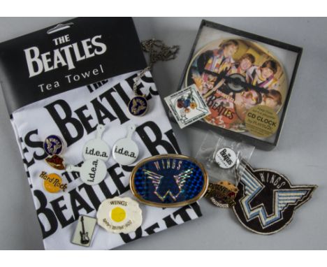 Paul McCartney / The Beatles, A collection of Badges, Buckles, Necklace etc together with A Beatles Tea Towel and CD Clock 