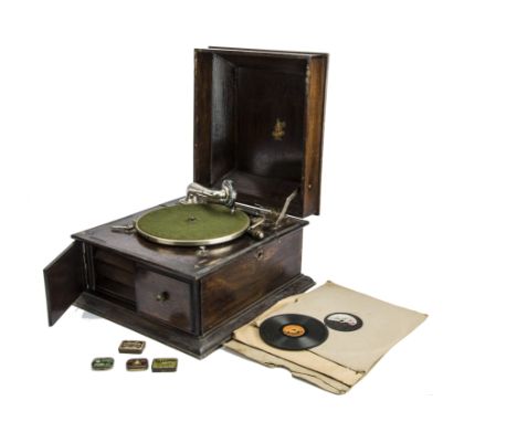 An Apollo table grand gramophone, in oak case, with replacement soundbox, Tritona and three other needle tins and 24 acoustic