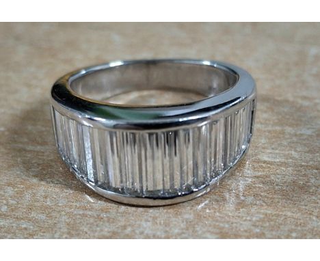 Diamond half eternity ring set in Platinum, channel set with 19 long baguette cut diamonds, graduating in length towards the 