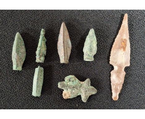 Four bronze 3-bladed arrow heads, probably Roman, together with a part bronze stem and another flattened bronze arrowhead and