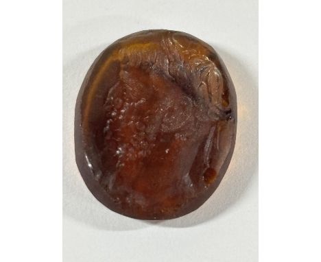 Ancient intaglio, believed to be Roman, depicting a Roman/Greek man in profile carved into a carnelian,Please note - The vend