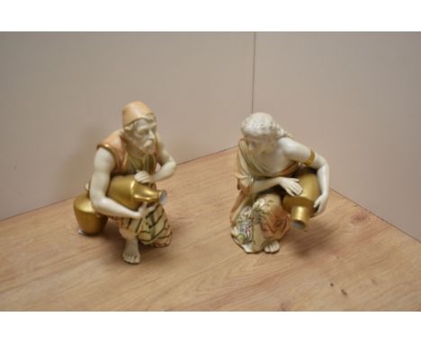 A pair of early 20th century Royal Worcester bone china 'blush ivory' kneeling Eastern water carrier figures, originally desi