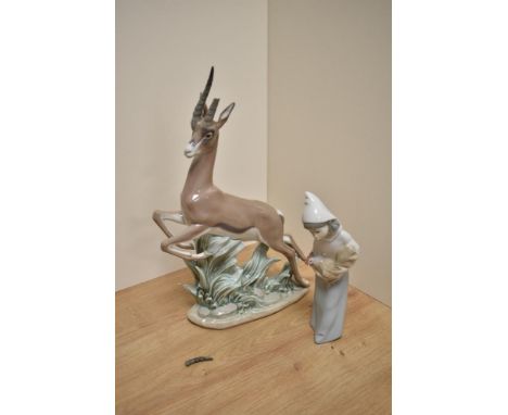 A Lladro porcelain Gazelle study, 5271, modelled leaping over foliage, printed marks to underside 32.5cm depletion to one hor
