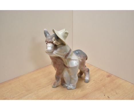 A Lladro porcelain figure group 'Platero &amp; Marcelino' boy with donkey, 20.5cm small flake to hat rim.