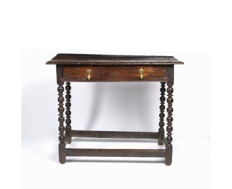 Oak side table 17th/18th century, with bobbin turned supports and a single drawer to the front, 70cm high x 88cm across