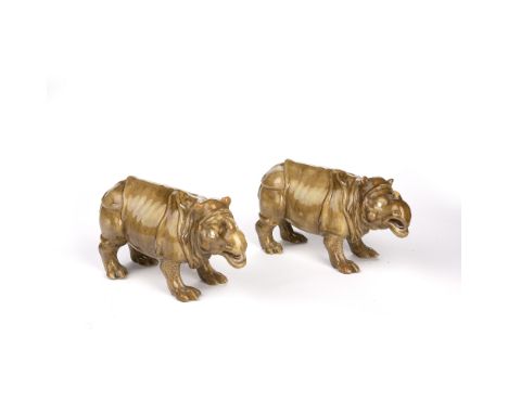 Two Royal Worcester models of a rhinoceros impressed factory marks, glazed in olive-coloured majolica finish